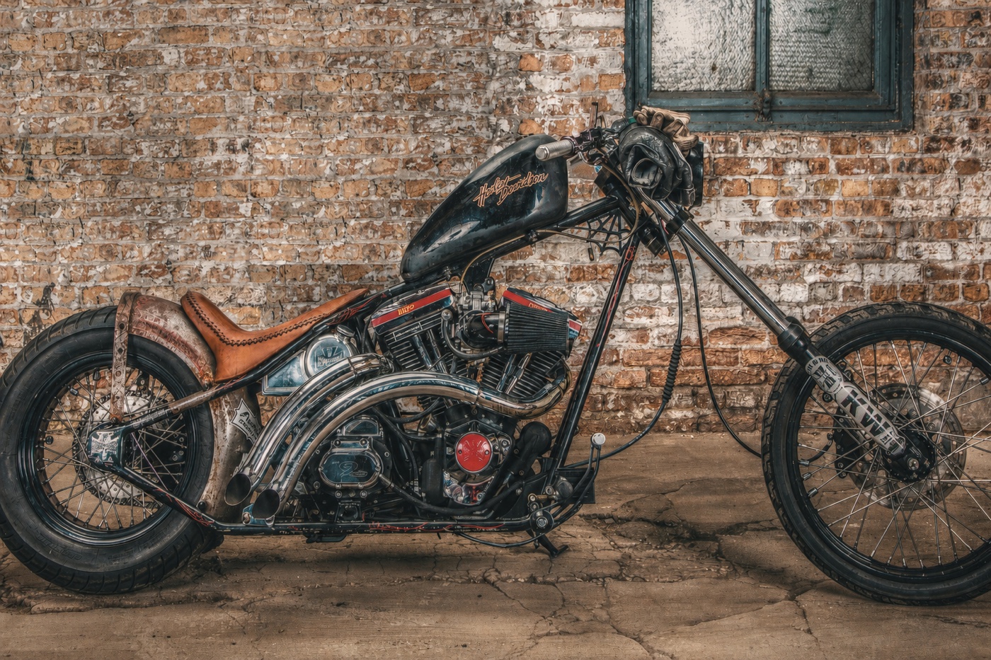 Custom hot rod and motorcycles parked together in a garage
